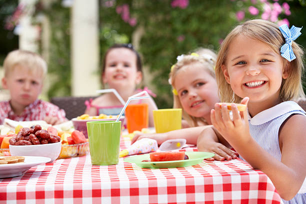 istock Group of children at a picnic table smiling 158485897