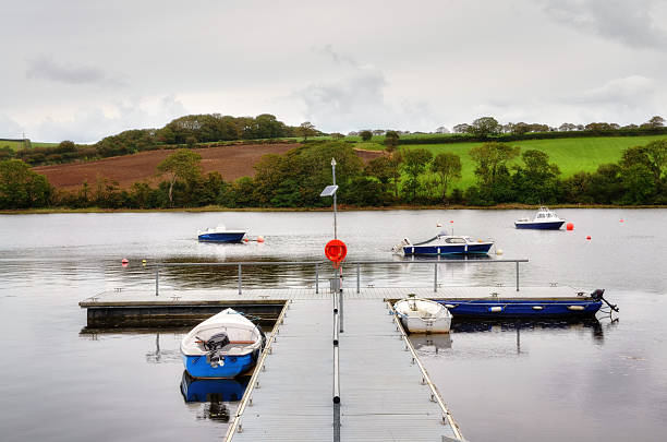 Jetty on the River Teifi at St Dogmales, Cardigan. View of a jetty with moored boats, on the tranquil River Teifi,at St Dogamaels, a village near Cardigan, known in Welsh as Llandudoch. teifi river stock pictures, royalty-free photos & images