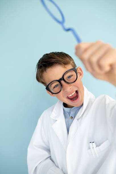 istock young mad scientist with white coat and blue ring 1584860541