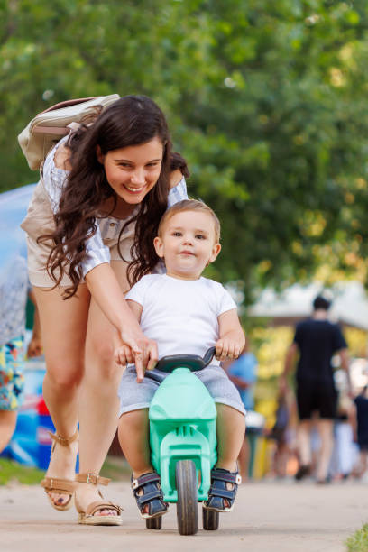 istock Mother helping son learn to ride a bike 1584868106