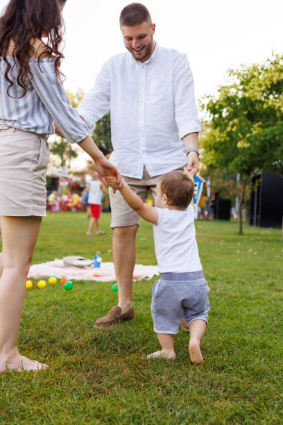 istock Parents playing with their toddler in the park 1584897575