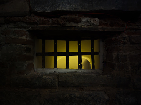 the barred window of the dungeon was illuminated with yellow light