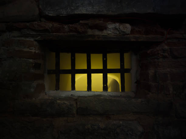 the barred window of the dungeon was illuminated with yellow light the barred window of the dungeon was illuminated with yellow light old folsom stock pictures, royalty-free photos & images