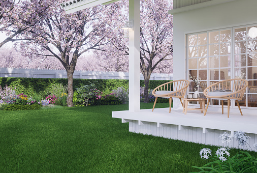Vintage style white house terrace with flower garden view 3d render decorated with wooden chair in front of bedroom window and empty green lawn for copy space