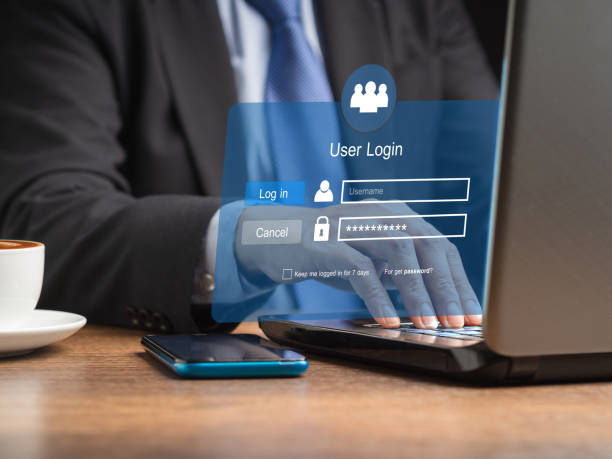 istock Businessman using a laptop login to the network system on a virtual screen 1584946747
