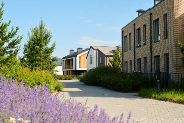 istock Two storey brick building standing against other cottages 1584948458