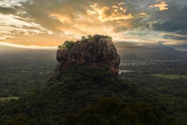 istock the sun sets behind a rocky mountain and sky line with the trees in front of 1584958519