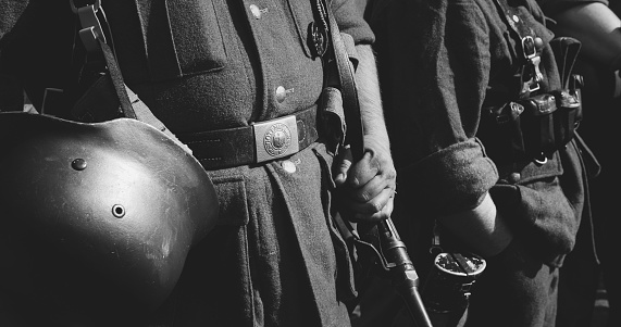 Close-up View On Re-enactor Dressed As German Wehrmacht Infantry Soldier In World War Ii. German Soldier Uniform. German Soldier's Outfit. Black And White .
