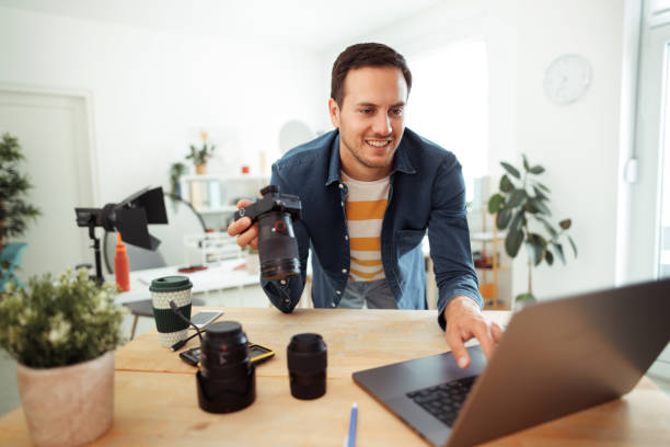 istock Young casually clothed photographer working at home office 1584967069