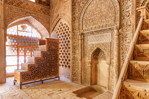 Isfahan, Iran - 23 October, 2018: Awesome sanctuary and two ancient wooden carved stands used for preaching inside the Jameh Mosque of Isfahan. Amazing interior of the Muslim place.