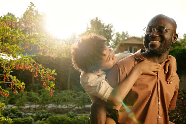 istock Young cheerful African American man having fun with his cute son 1585015708
