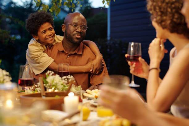 istock Happy boy embracing his father looking at his wife during conversation 1585018451