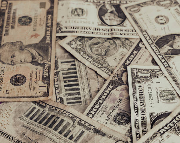 istock Money pile with different dollar bills 1585021165