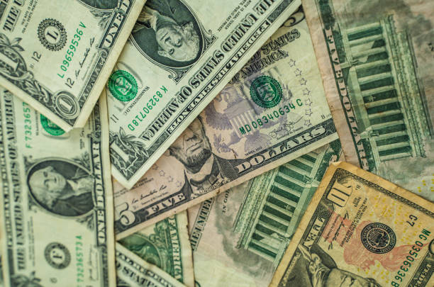 istock Dollar banknotes on a big pile 1585025999