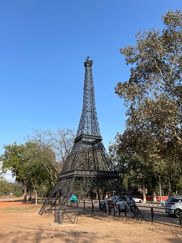 Leisure Valley, Sector 10, Chandigarh, India - March, 1 2023: Stock photo showing a replica Eiffel Tower, Chandigarh, India a popular landmark with local young men who park their luxury, foreign manufactured cars in order to pose along side and take photographs.
