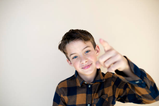 istock cool boy with checkered shirt against brown background 1585038456