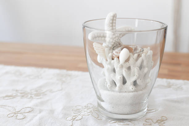 Starfish and corals in the glass on a blue background