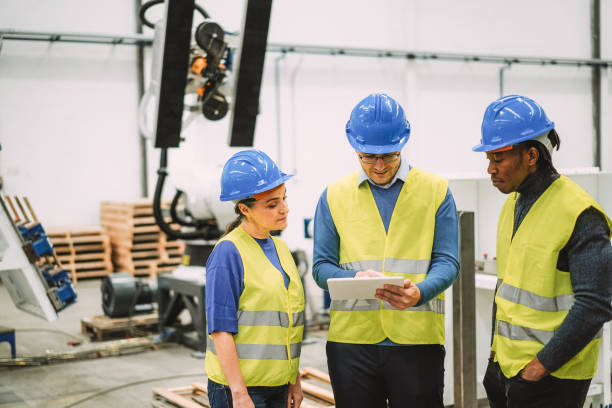 istock Engineers working at new AI prototype inside robotic factory - Future, job and technology concept - Mani focus on center man face 1585071983