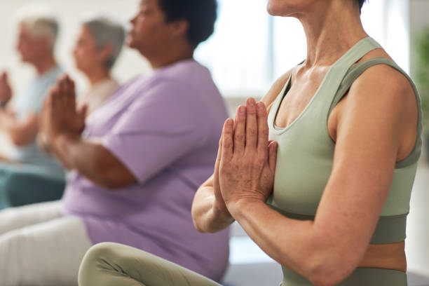 istock People meditating in lotus position in class 1585075892