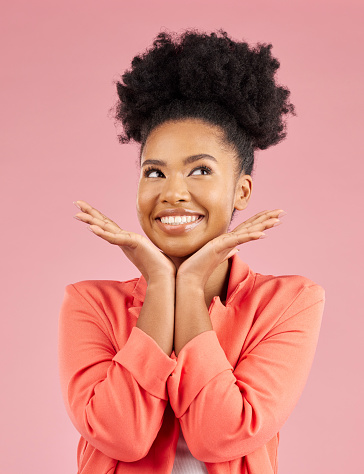 Fashion, beauty and thinking with an afro woman in studio isolated on pink background for trendy style. Smile, hair and idea with a happy or confident young african person posing in a clothes outfit