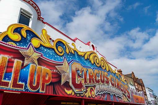 Circus sign outside a big top with blue sky behind
