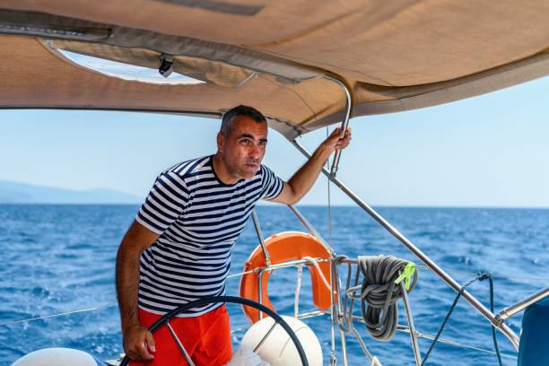 istock Man is driving a sailboat and enjoying it. 1585111238