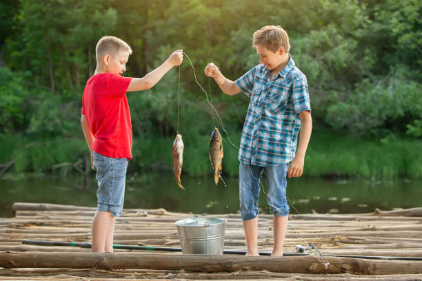 Free Stock Photo of Two Boys Stand in Water With Fishing Nets ...