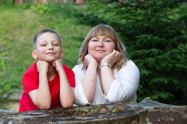 istock Happy mom and son are looking at the camera smiling. 1585132027