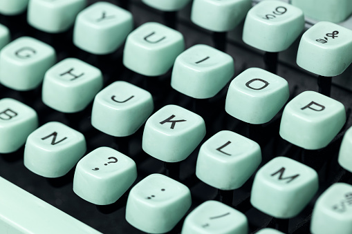 Close up of a vintage green typewriter keys. Selective focus