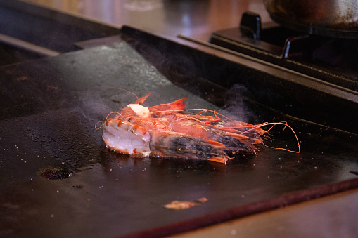 Bergens world famous outdoor food market showing off its natural produce from land and sea with a large shrimp cooking on the hot plate