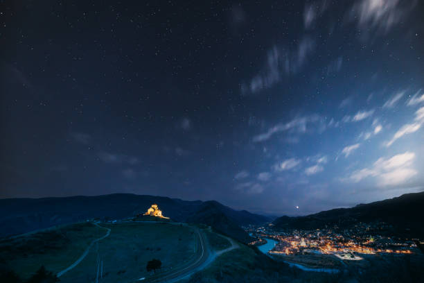 istock Mtskheta, Georgia. Ancient Jvari, Georgian Orthodox Monastery In Night Illuminations Lighting. World Heritage Site By UNESCO. Beautiful Mountain Landscape And Old Temple During Autumn Night 1585140438