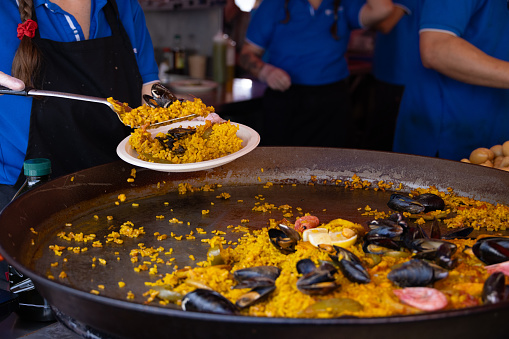 Bergens world famous outdoor food market showing off its natural produce from land and sea with fresh seafood paella being cooked and plated up