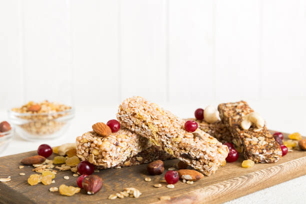 istock Various granola bars on table background. Cereal granola bars. Superfood breakfast bars with oats, nuts and berries, close up. Superfood concept 1585145962