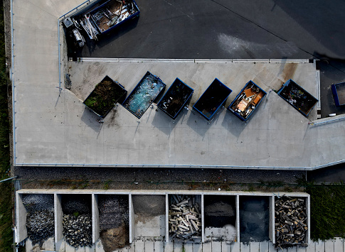 recycling yard with a ramp for dumping and sorting waste into containers. glass. Materials such as glass, metal, wood have their own boxes. vertical view from above, bream