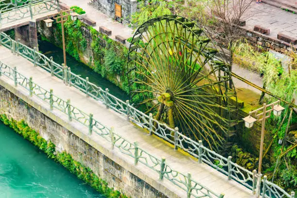 Awesome aerial view of water wheel on the Tuojiang River (Tuo Jiang River) in Phoenix Ancient Town (Fenghuang County), China. Fenghuang is a popular tourist destination of Asia.