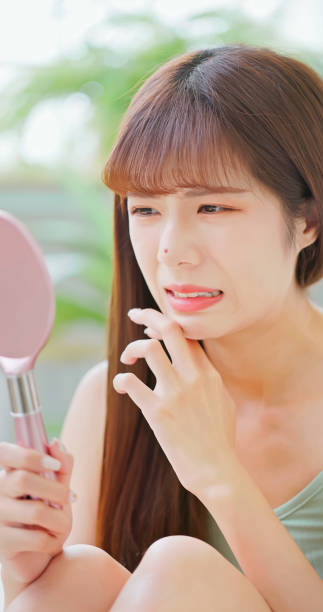 istock woman with pimple 1585179095