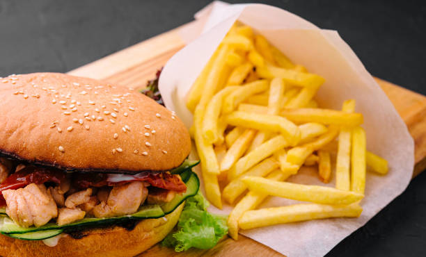 istock Burger with fries on wooden rustic Board 1585182324