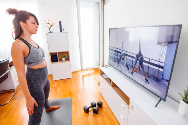 istock Woman warming up for home workout 1585188570