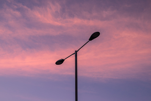 The street lamp post stands up in magic hour