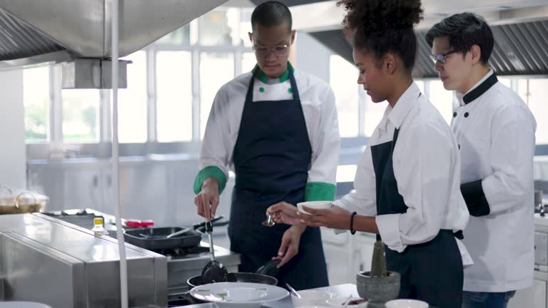 culinary students learning from chef at cooking school