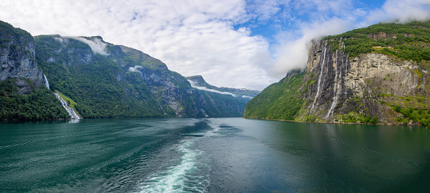 Hires panoramic showing the Seven Sisters water fall on the right and the 'Suitor (Friaren)' or Bottle waterfall on the left in a Norwegian fjord on the way to the beautiful town of Geiranger