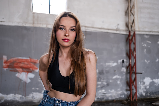 Young woman posing in deserted building.