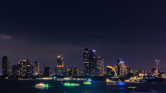 Cityscape over colors and the lights of pattaya and cruise ships in the sea, pattaya bay at night, Bali Hai View Point,