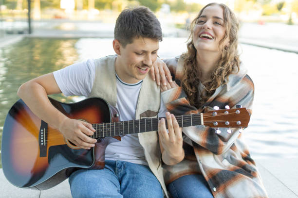 istock Romantic Couple With Guitar 1585252316