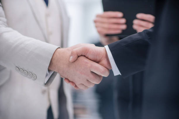 close up. business handshake on the background of the office stock photo