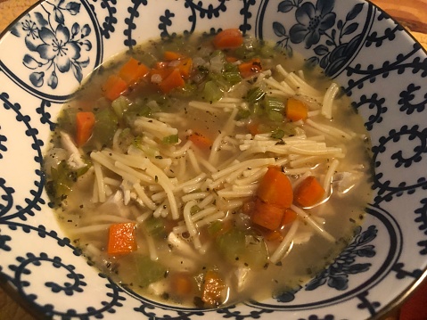 Homemade chicken soup with fideo noodles carrots onions celery