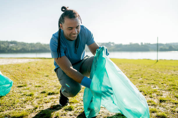 istock Latin man picking up trash in the park 1585292709