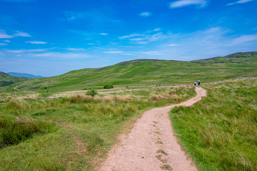 Balmaha, Scotland - June 10, 2022: Hikers on the West Highland Way in the Scottish Highlands near Loch Lomond.