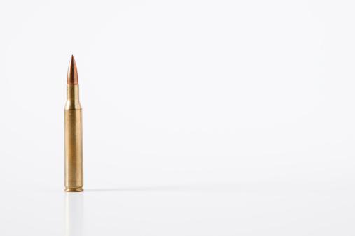 Studio shot of a rifle-bullet, isolated on white with copy space.