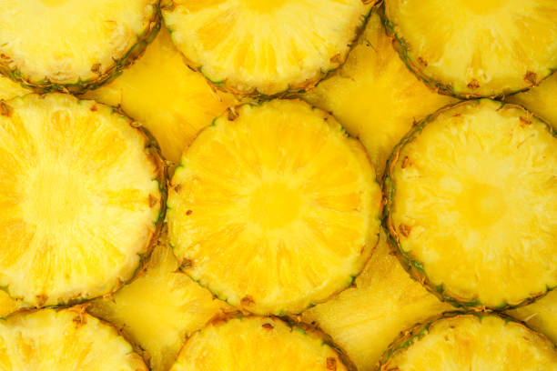 istock Pineapple juicy yellow slices as a background. 1585329882